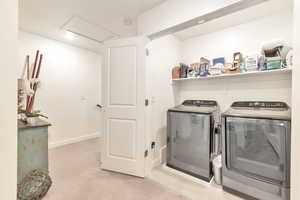 Clothes washing area featuring washing machine and dryer