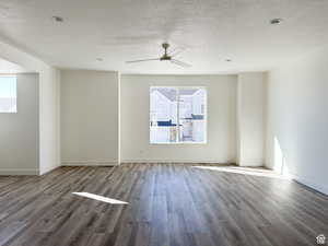 Unfurnished room featuring ceiling fan, hardwood / wood-style flooring, and a textured ceiling