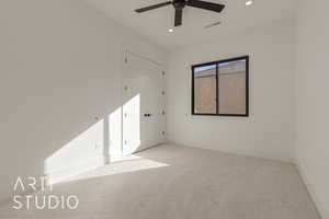 Spare room featuring light colored carpet and ceiling fan