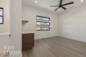 Spare room featuring hardwood / wood-style floors and ceiling fan