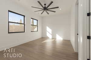 Empty room with hardwood / wood-style flooring and ceiling fan