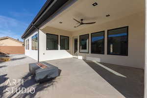 View of patio / terrace with ceiling fan and a fire pit