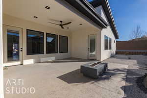 View of patio / terrace with ceiling fan and a fire pit