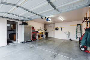 Garage featuring a garage door opener and a storage area