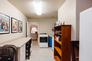 Washroom with washer / clothes dryer and a textured ceiling