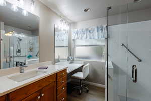 Bathroom featuring vanity, hardwood / wood-style floors, and a shower with shower door