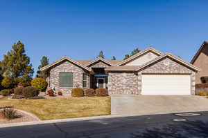 Ranch-style home with a garage and a front lawn