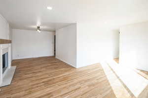 Unfurnished living room with light hardwood / wood-style floors