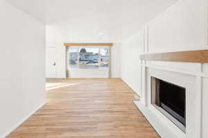 Unfurnished living room with light hardwood / wood-style flooring