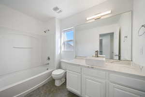 Full bathroom with vanity, tile patterned flooring, bathing tub / shower combination, and toilet