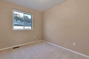 Empty room featuring carpet floors