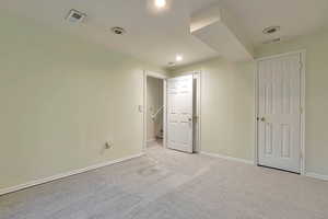 Unfurnished bedroom with light carpet