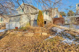 View of side of property with a garage