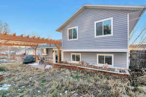 Back of house featuring a pergola and a patio area