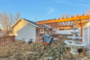 Rear view of house featuring a pergola