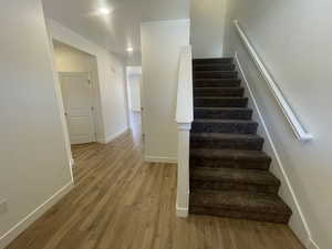 Staircase with hardwood / wood-style floors