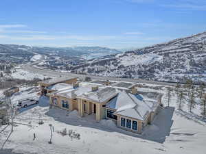 Snowy aerial view featuring a mountain view