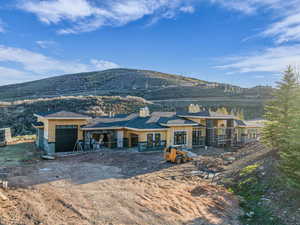Back of property with a mountain view, a chimney, and french doors