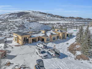 Snowy aerial view featuring a mountain view