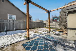 Backyard view from back door.  Cement pad and pergula (included)