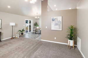 Interior space featuring high vaulted ceiling and a notable chandelier