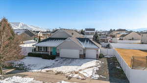 View of front of property with a mountain view, a garage, and covered porch