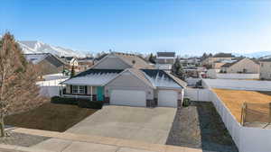 View of front of property featuring a mountain view, a garage, and covered porch