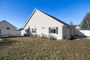 Rear view of property with a yard