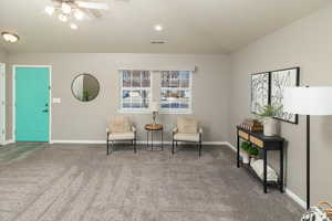 Sitting room featuring carpet and ceiling fan