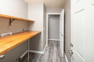 Interior space featuring electric dryer hookup, hardwood / wood-style floors, and washer hookup