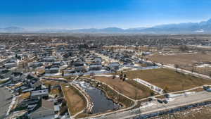 Birds eye view of property featuring a water and mountain view