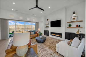 Living room with wood-type flooring and ceiling fan