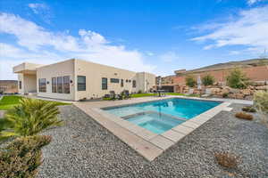 View of swimming pool featuring an in ground hot tub and a patio