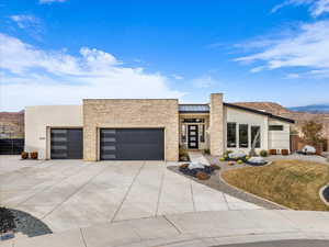 Contemporary house featuring a garage and a mountain view