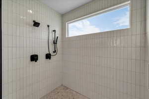 Bathroom featuring tiled shower