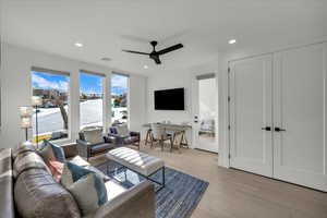 Living room featuring ceiling fan and light hardwood / wood-style floors