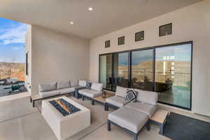 View of patio with an outdoor living space with a fire pit