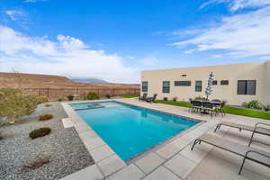 View of swimming pool featuring a mountain view and a patio area