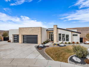 Contemporary house featuring a garage and a front yard