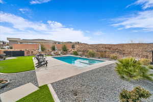 View of swimming pool with a patio area and a lawn