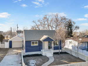 View of front of property with an outbuilding and a garage