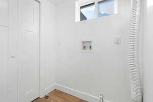 Laundry area featuring hardwood / wood-style flooring and hookup for a washing machine