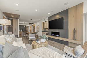 Living room with sink, a fireplace, and hardwood / wood-style floors