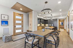 Dining space with light hardwood / wood-style flooring