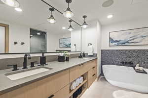 Bathroom featuring vanity, tile patterned floors, and plus walk in shower