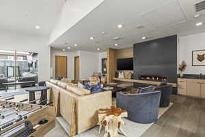 Living room featuring a fireplace, sink, and light wood-type flooring