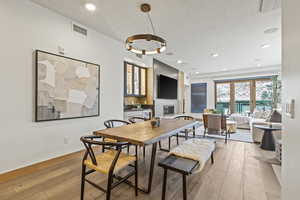 Dining room with light hardwood / wood-style flooring