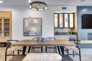 Dining area featuring beverage cooler and indoor wet bar