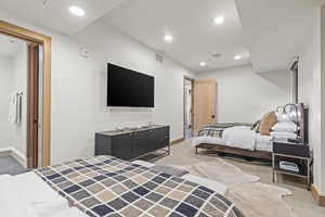 Carpeted bedroom with a closet