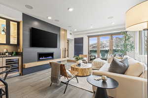 Living room featuring bar, hardwood / wood-style floors, a fireplace, and beverage cooler